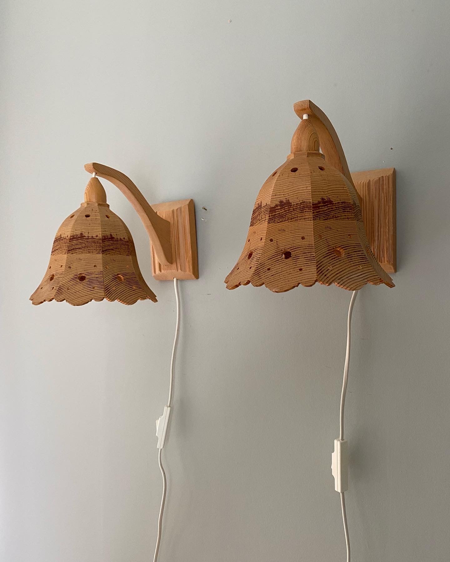 A pair of vintage wooden hanging wall lights