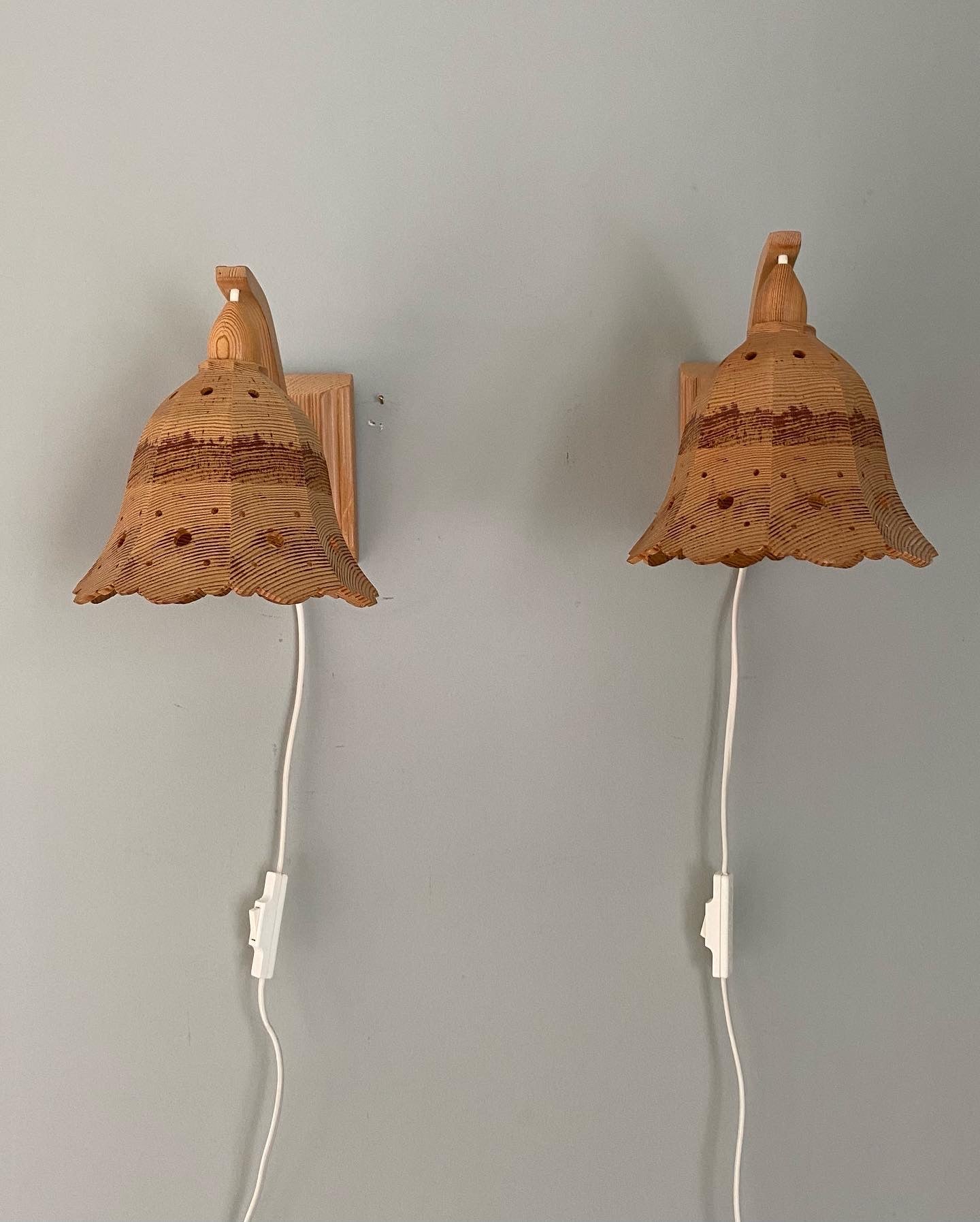 A pair of vintage wooden hanging wall lights