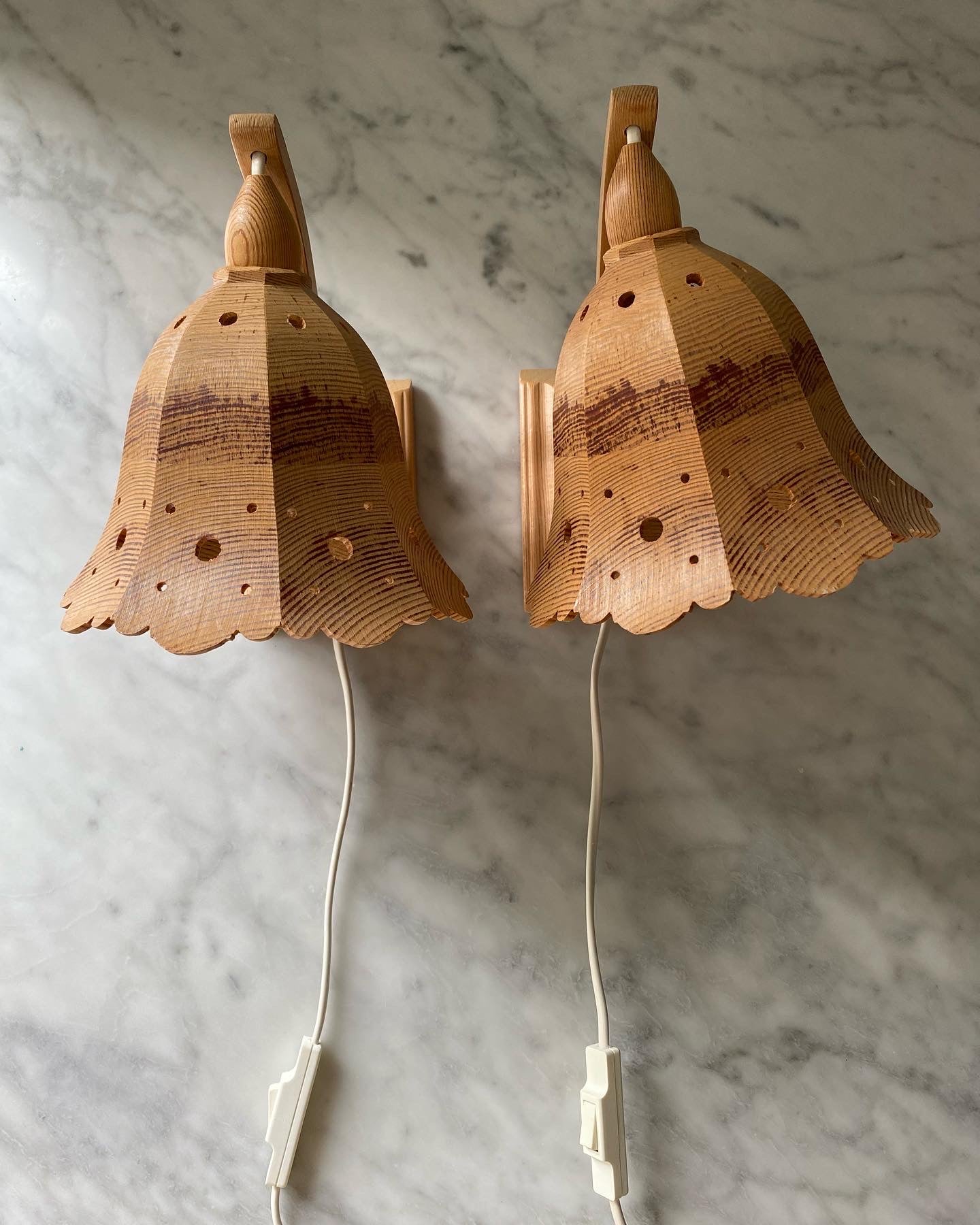 A pair of vintage wooden hanging wall lights