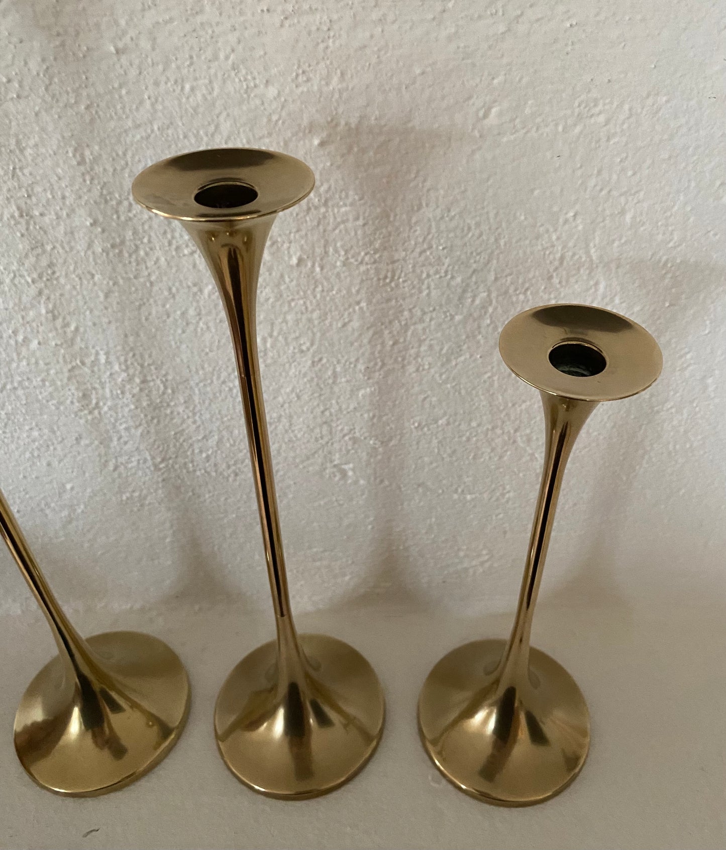 Set of three brass candle holders